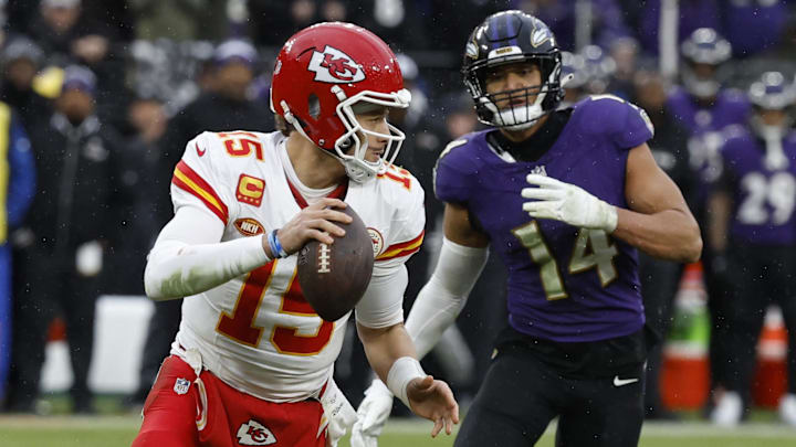 Jan 28, 2024; Baltimore, Maryland, USA; Kansas City Chiefs quarterback Patrick Mahomes (15) scrambles from Baltimore Ravens safety Kyle Hamilton (14) in the AFC Championship football game at M&T Bank Stadium. Mandatory Credit: Geoff Burke-Imagn Images
