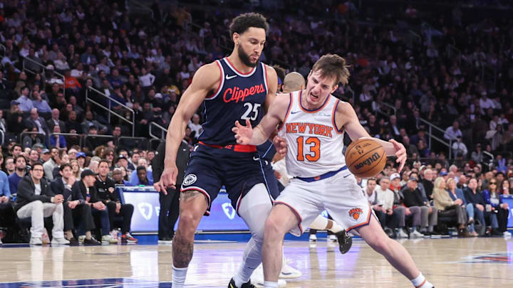 Mar 26, 2025; New York, New York, USA;  New York Knicks guard Tyler Kolek (13) looks to drive past LA Clippers guard Ben Simmons (25) in the third quarter at Madison Square Garden. Mandatory Credit: Wendell Cruz-Imagn Images