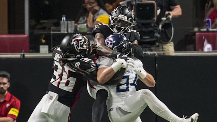 Tennessee Titans tight end Gunnar Helm catches a touchdown pass defended by Atlanta Falcons safety Jordan Fuller. Mandatory Credit: Dale Zanine-Imagn Images