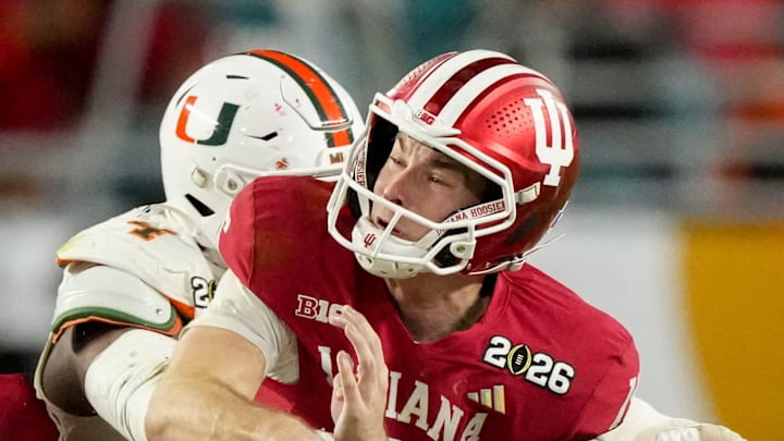 Miami (FL) Hurricanes defensive lineman Rueben Bain Jr. (4) wraps up Indiana Hoosiers quarterback Fernando Mendoza (15) on Monday, Jan. 19, 2026, during the College Football Playoff National Championship college football game at Hard Rock Stadium in Miami Gardens. Miami (FL) Hurricanes defensive lineman Rueben Bain Jr. (4) wraps up Indiana Hoosiers quarterback Fernando Mendoza (15) on Monday, Jan. 19, 2026, during the College Football Playoff National Championship college football game at Hard Rock Stadium in Miami Gardens.
