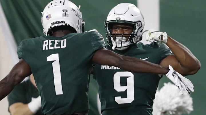 Oct 2, 2021; East Lansing, Michigan, USA; Michigan State Spartans running back Kenneth Walker III (9) celebrates with wide receiver Jayden Reed (1) after rushing for a touchdown against the Western Kentucky Hilltoppers during the first quarter at Spartan Stadium. Mandatory Credit: Raj Mehta-Imagn Images