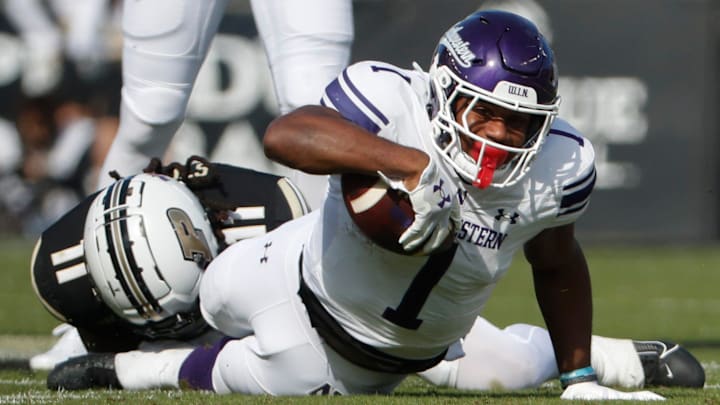 Purdue Boilermakers defensive back Antonio Stevens (11) tackles Northwestern Wildcats running back Cam Porter (1) Saturday, Nov. 2, 2024, during the NCAA football game at Ross-Ade Stadium in West Lafayette, Ind.