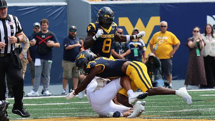 West Virginia University safety Andrew Powdrell (0) makes the tackle while teammate, safety Kamari Wilson (8) closes in. West Virginia University safety Andrew Powdrell (0) makes the tackle while teammate, safety Kamari Wilson (8) closes in.