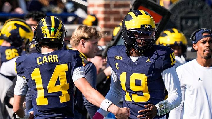 Michigan quarterback Bryce Underwood (19) hugs quarterback Tommy Carr (14) after a play against Indiana during the first half at Michigan Stadium in Ann Arbor on Saturday, Oct. 24, 2026.