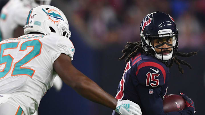 Houston Texans wide receiver Will Fuller (15) runs the ball as Miami Dolphins linebacker Raekwon McMillan (52) closes in during the second quarter at NRG Stadium.