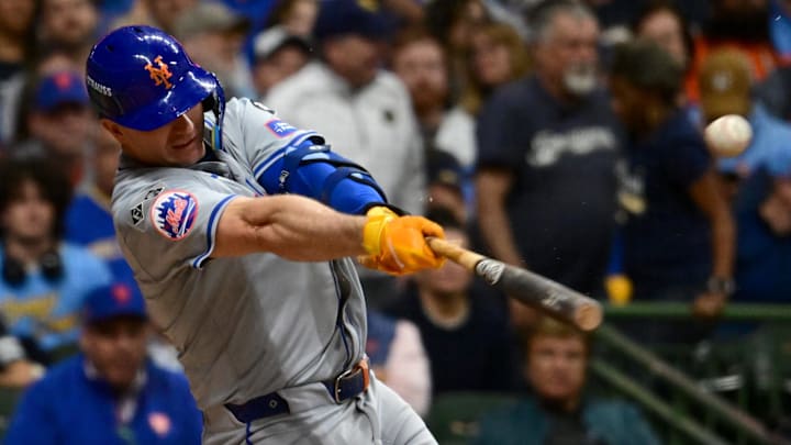 Oct 2, 2024; Milwaukee, Wisconsin, USA; New York Mets first baseman Pete Alonso (20) hits a broken bat single during the seventh inning in game two of the Wildcard round for the 2024 MLB Playoffs against the Milwaukee Brewers at American Family Field. Mandatory Credit: Benny Sieu-Imagn Images