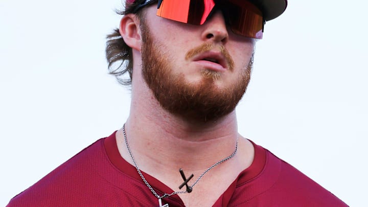 Crosses bounce on a necklace of Florida State outfielder James Tibbs III (22) as he runs into the