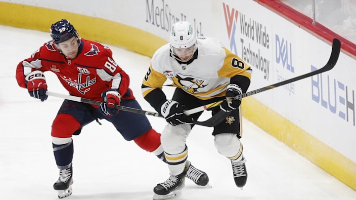 Nov 8, 2024; Washington, District of Columbia, USA; Pittsburgh Penguins left wing Michael Bunting (8) and Washington Capitals left wing Andrew Mangiapane (88) battle for the puck in the first period at Capital One Arena. Mandatory Credit: Geoff Burke-Imagn Images
