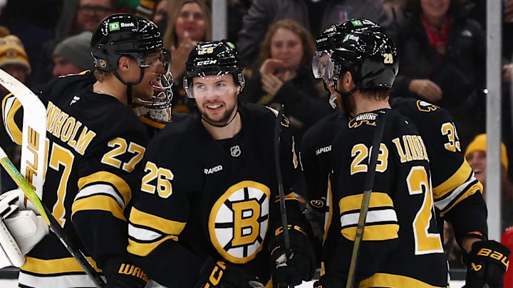 Dec 6, 2025; Boston, Massachusetts, USA; Boston Bruins defenseman Andrew Peeke (26) smiles after scoring his first goal of the season during the third period against the New Jersey Devils at TD Garden. Mandatory Credit: Winslow Townson-Imagn Images