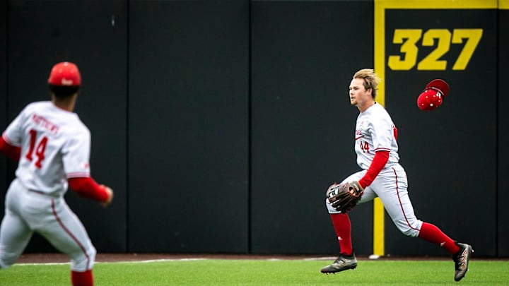 Nebraska Cornhuskers' Gabe Swansen loses his cap while running to field a ball.