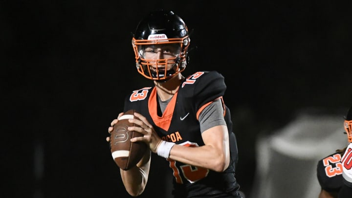 Cocoa QB Brady Hart rolls away from the Dunnellon defense to pass during their game in the FHSAA Cocoa QB Brady Hart rolls away from the Dunnellon defense to pass during their game in the FHSAA