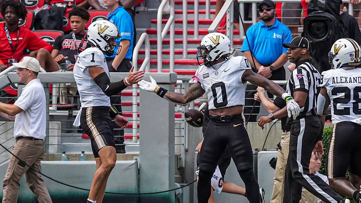 Oct 3, 2026; Athens, Georgia, USA; Vanderbilt Commodores wide receiver Junior Sherrill (0) reacts with quarterback Blaze Berlowitz (1) after scoring a touchdown against the Georgia Bulldogs at Sanford Stadium. Mandatory Credit: Dale Zanine-Imagn Images Oct 3, 2026; Athens, Georgia, USA; Vanderbilt Commodores wide receiver Junior Sherrill (0) reacts with quarterback Blaze Berlowitz (1) after scoring a touchdown against the Georgia Bulldogs at Sanford Stadium. Mandatory Credit: Dale Zanine-Imagn Images