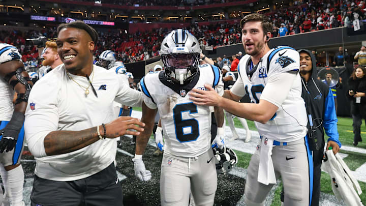 Jan 5, 2025; Atlanta, Georgia, USA; Carolina Panthers running back Miles Sanders (6) celebrates with teammates after a game-winning touchdown in overtime against the Atlanta Falcons at Mercedes-Benz Stadium. 