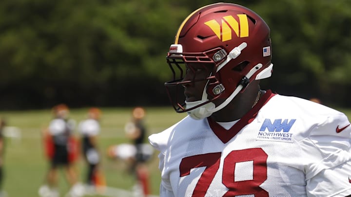 Washington Commanders offensive tackle Laremy Tunsil stands on the field on day one of minicamp at Commanders Park.