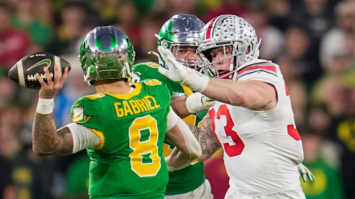 Ohio State Buckeyes defensive end Jack Sawyer (33) pursues Oregon Ducks quarterback Dillon Gabriel (8) during the College Football Playoff quarterfinal at the Rose Bowl in Pasadena, Calif. on Jan. 1, 2025. Ohio State won 41-21.