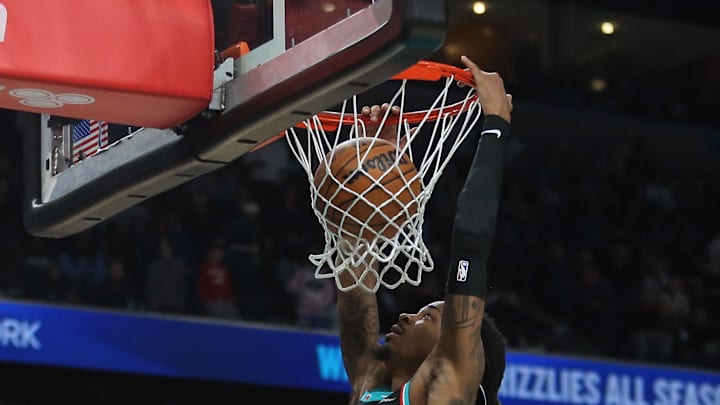Dec 30, 2025; Memphis, Tennessee, USA; Memphis Grizzlies guard Ja Morant (12) dunks during overtime against the Philadelphia 76ers at FedExForum. Mandatory Credit: Petre Thomas-Imagn Images