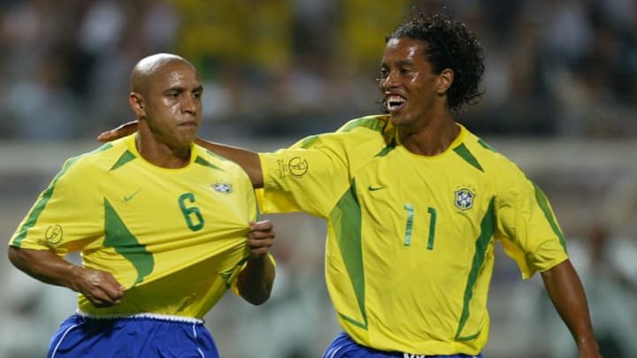 Brazil's Roberto Carlos (L) is congratulated by te