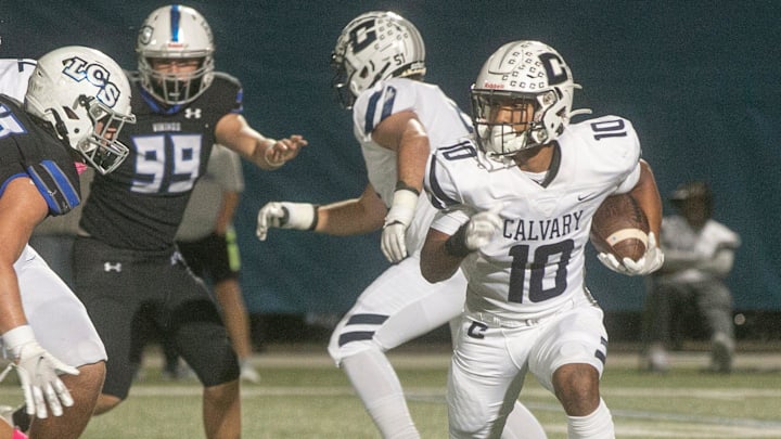 Calvary Christian School running back Sean Cuono (10) rushes the ball against Lakeland Christian School during the first half at Lakeland Christian School in Lakeland Friday night. October 21, 2022.