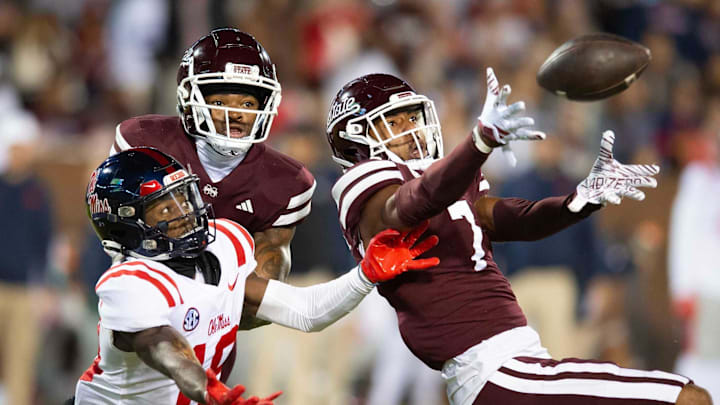 Mississippi State's Shawn Preston Jr. (7), with the support of Daijahn Anthony (3), reaches to