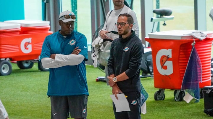 Miami Dolphins general manager Chris Grier and head coach Mike McDaniel watch training camp at