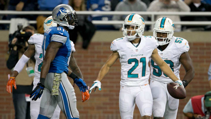Miami Dolphins cornerback Brent Grimes (21) celebrates his interception of a pass intende for Detroit Lions wide receiver Calvin Johnson (81) at Ford Field in 2014. Miami Dolphins cornerback Brent Grimes (21) celebrates his interception of a pass intende for Detroit Lions wide receiver Calvin Johnson (81) at Ford Field in 2014.