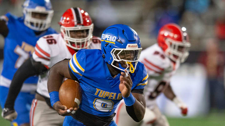 Tupelo's Jaeden Hill (0) gains yardage against Brandon defenders during the MHSAA 7A championship game in Hattiesburg, Miss., Thursday, Dec. 5, 2024.
