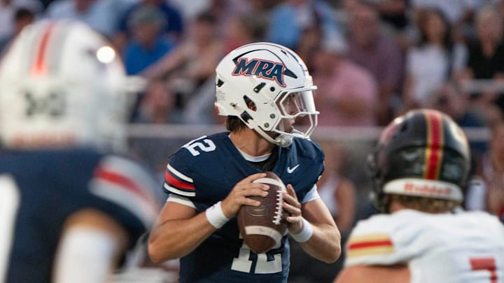 MRA quarterback Samuel Stockett (12) looks for an opening during play against Ravenwood in Madison, Miss., Friday, Aug. 22, 2025.