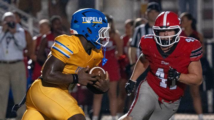 Tupelo's Kylan Bobo (29) carries for yardage as Brandon's Reece Quinn (41) closes in during play in Brandon, Miss., Friday, Aug. 29, 2025. Tupelo won 36-15.