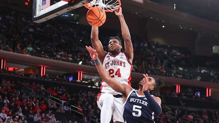 Jan 28, 2026; New York, New York, USA; St. John's basketball forward Zuby Ejiofor (24) dunks past Butler Bulldogs forward Michael Ajayi (5) in the second half at Madison Square Garden. Jan 28, 2026; New York, New York, USA; St. John's basketball forward Zuby Ejiofor (24) dunks past Butler Bulldogs forward Michael Ajayi (5) in the second half at Madison Square Garden.