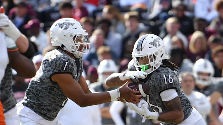 Nov 22, 2025; Blacksburg, Virginia, USA; Virginia Tech Hokies quarterback Kyron Drones (1) hands the ball off to Virginia Tech Hokies running back Jeffrey Overton (16) during the second quarter at Lane Stadium. Mandatory Credit: Brian Bishop-Imagn Images
