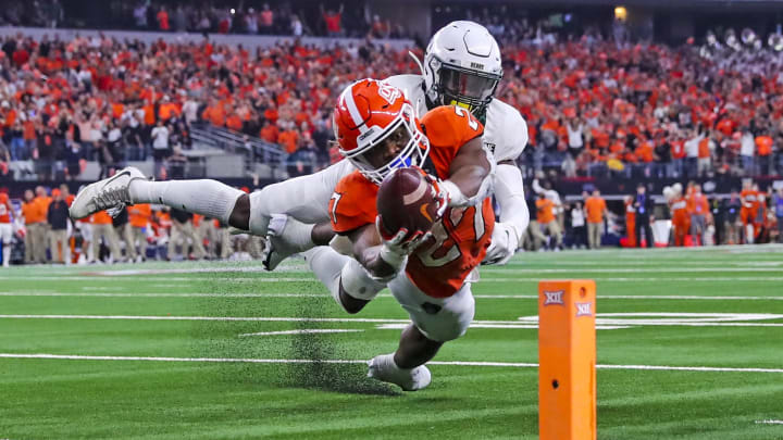 Dec 4, 2021; Arlington, TX, USA; Baylor Bears safety Jairon McVea (42) stops Oklahoma State Cowboys running back Dezmon Jackson (27) from scoring a touchdown during the fourth quarter of the Big 12 Conference championship game at AT&T Stadium. Mandatory Credit: Kevin Jairaj-USA TODAY Sports