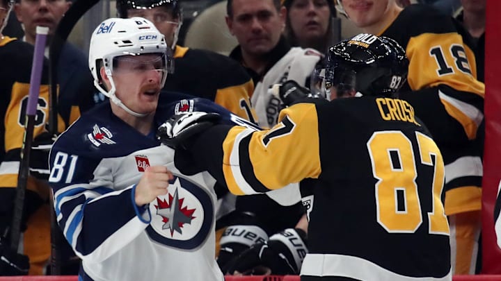 Nov 22, 2024; Pittsburgh, Pennsylvania, USA; Winnipeg Jets left wing Kyle Connor (81) and Pittsburgh Penguins center Sidney Crosby (87) fight during the second period at PPG Paints Arena. Mandatory Credit: Charles LeClaire-Imagn Images