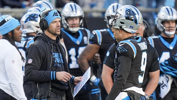 Dec 22, 2024; Charlotte, North Carolina, USA; Carolina Panthers head coach Dave Canales talks with quarterback Bryce Young (9) during a time out during the second half against the Arizona Cardinals at Bank of America Stadium. Mandatory Credit: Jim Dedmon-Imagn Images