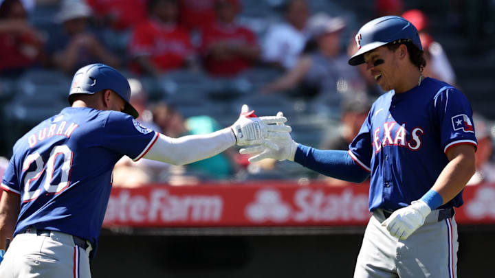 Sep 29, 2024; Anaheim, California, USA; Texas Rangers designated hitter Dustin Harris (38) celebrates with third baseman Ezequiel Duran (20) after hitting a home run, his first MLB home run, during the ninth inning against the Los Angeles Angels at Angel Stadium. Sep 29, 2024; Anaheim, California, USA; Texas Rangers designated hitter Dustin Harris (38) celebrates with third baseman Ezequiel Duran (20) after hitting a home run, his first MLB home run, during the ninth inning against the Los Angeles Angels at Angel Stadium.