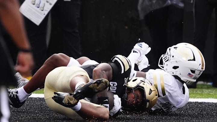 Aug 29, 2025; Boulder, Colorado, USA; Colorado Buffaloes running back Dekalon Taylor (20) scores a touchdown in front of Georgia Tech Yellow Jackets defensive back Clayton Powell-Lee (5) in the first quarter at Folsom Field. Mandatory Credit: Ron Chenoy-Imagn Images