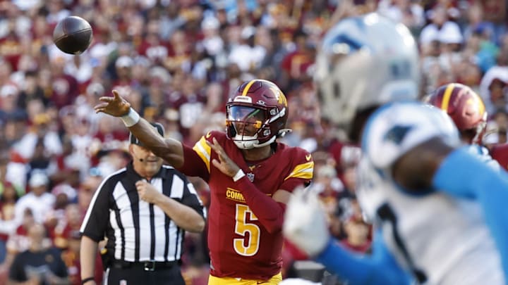 Oct 20, 2024; Landover, Maryland, USA; Washington Commanders quarterback Jayden Daniels (5) passes the ball against the Carolina Panthers during the first quarter at Northwest Stadium. Mandatory Credit: Geoff Burke-Imagn Images