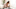 Very sick young woman sitting on a couch holding her forearm and handkerchief at her nose fighting fever. Very sick young woman sitting on a couch holding her forearm and handkerchief at her nose fighting fever.