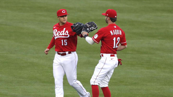 Cincinnati Reds out fielder Nick Senzel (15) reacts with centerfielder Tyler Naquin.