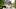 Girl (5-7) sitting at table setting, smiling Girl (5-7) sitting at table setting, smiling