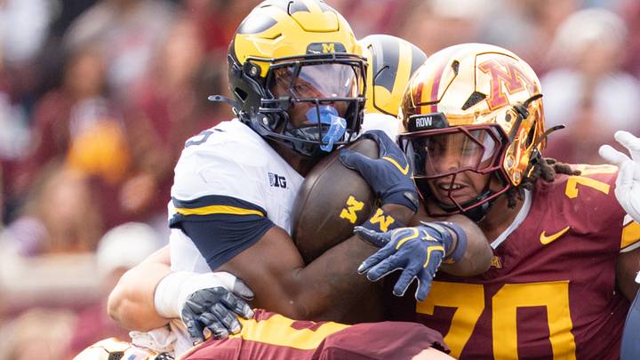 Oct 3, 2026; Minneapolis, Minnesota, USA; Michigan Wolverines running back Savion Hiter (5) is tackled by Minnesota Golden Gophers defensive lineman Naquan Crowder (70) and linebacker Maverick Baranowski (6) in the fourth quarter at Huntington Bank Stadium. Mandatory Credit: Matt Blewett-Imagn Images Oct 3, 2026; Minneapolis, Minnesota, USA; Michigan Wolverines running back Savion Hiter (5) is tackled by Minnesota Golden Gophers defensive lineman Naquan Crowder (70) and linebacker Maverick Baranowski (6) in the fourth quarter at Huntington Bank Stadium. Mandatory Credit: Matt Blewett-Imagn Images