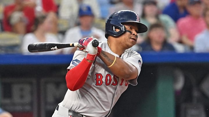 Aug 5, 2024; Kansas City, Missouri, USA;  Boston Red Sox third baseman Rafael Devers (11) singles in the fifth inning against the Kansas City Royals at Kauffman Stadium. Mandatory Credit: Peter Aiken-Imagn Images