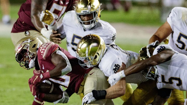 Florida State Seminoles running back Jashaun Corbin (0) is tackled by a Notre Dame player. The Notre Dame Fighting Irish defeat the Florida State Seminoles 41-38 at Doak Campbell Stadium on Sunday, Sept. 5, 2021.