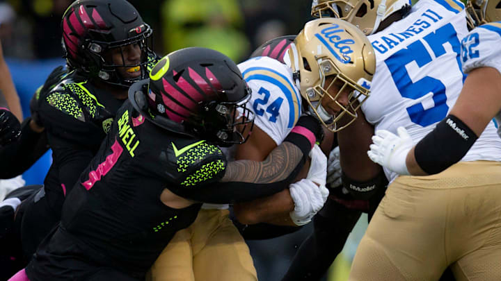 Oregon inside linebacker Noah Sewell wraps up UCLA running back Zach Charbonnet as the Oregon Ducks take on the UCLA Bruins Saturday, Oct. 22, 2022, at Autzen Stadium in Eugene, Ore.