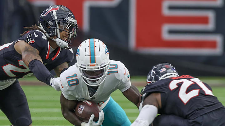 Dec 15, 2024; Houston, Texas, USA;  Miami Dolphins wide receiver Tyreek Hill (10) is tackled by Houston Texans safety Calen Bullock (21) in the second quarter at NRG Stadium. Mandatory Credit: Thomas Shea-Imagn Images