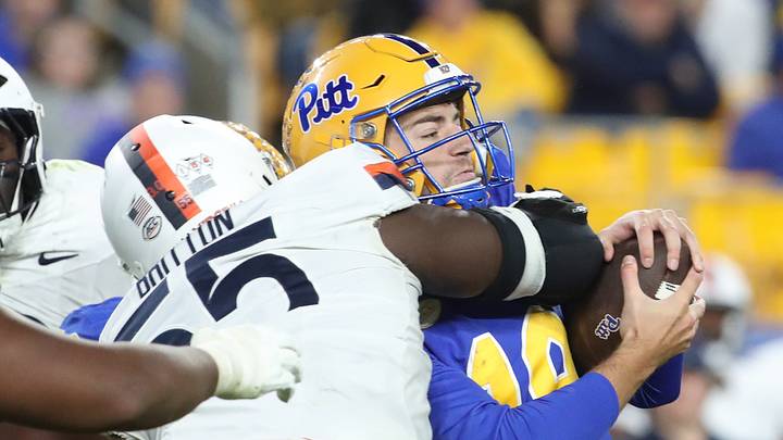Nov 9, 2024; Pittsburgh, Pennsylvania, USA; Virginia Cavaliers defensive tackle Anthony Britton (55) tackles Pittsburgh Panthers quarterback Nate Yarnell (19) during the third quarter at Acrisure Stadium. Mandatory Credit: Charles LeClaire-Imagn Images Nov 9, 2024; Pittsburgh, Pennsylvania, USA; Virginia Cavaliers defensive tackle Anthony Britton (55) tackles Pittsburgh Panthers quarterback Nate Yarnell (19) during the third quarter at Acrisure Stadium. Mandatory Credit: Charles LeClaire-Imagn Images