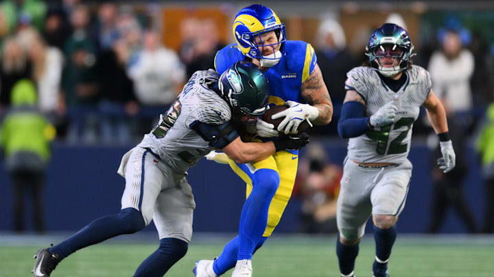 Dec 18, 2025; Seattle, Washington, USA; Seattle Seahawks safety Ty Okada (39) tackles Los Angeles Rams tight end Terrance Ferguson (18) in the second half at Lumen Field. 
