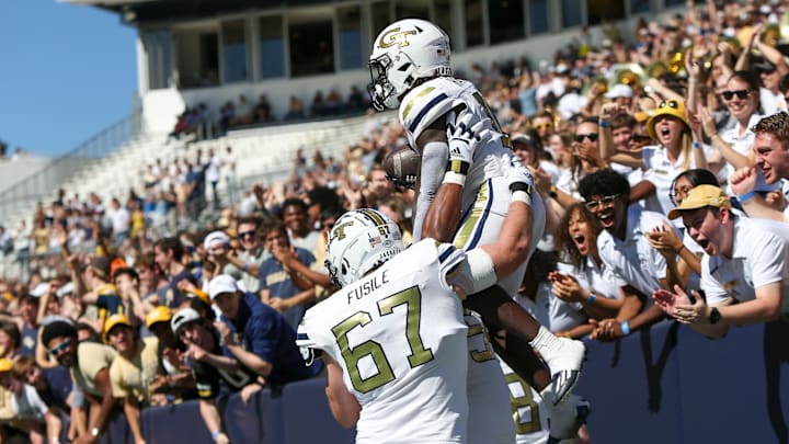 Oct 21, 2023; Atlanta, Georgia, USA; Georgia Tech Yellow Jackets running back Jamal Haynes (11) celebrates with offensive lineman Joe Fusile (67) after a touchdown run against the Boston College Eagles in the first quarter at Bobby Dodd Stadium at Hyundai Field. Mandatory Credit: Brett Davis-Imagn Images
