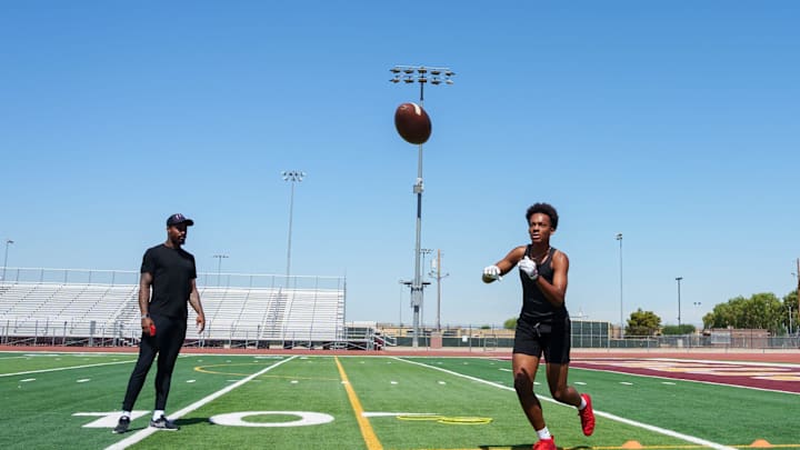 Former NFL wide receiver Jaelen Strong (left) watches Tolleson's Judah Lancaster during a private practice at Tolleson Union High School on June 16, 2023, in Tolleson.
