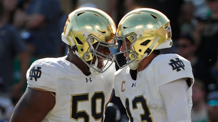 Notre Dame Fighting Irish quarterback Riley Leonard (13) celebrates with Notre Dame Fighting Irish offensive lineman Aamil Wagner (59) after scoring a touchdown Saturday, Sept. 14, 2024, during the NCAA football game against the Purdue Boilermakers at Ross-Ade Stadium in West Lafayette, Ind. Notre Dame Fighting Irish won 66-7.