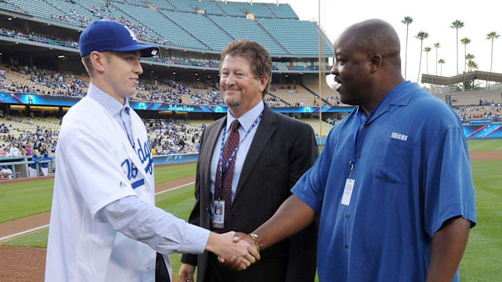 Los Angeles Dodgers first-round draft pick Chris Reed (left) shakes hands with area scout Orsino Hall (right) as assistant general manager Logan White (center) looks on before the game against the Houston Astros at Dodger Stadium on Aug. 12, 2011. Los Angeles Dodgers first-round draft pick Chris Reed (left) shakes hands with area scout Orsino Hall (right) as assistant general manager Logan White (center) looks on before the game against the Houston Astros at Dodger Stadium on Aug. 12, 2011.